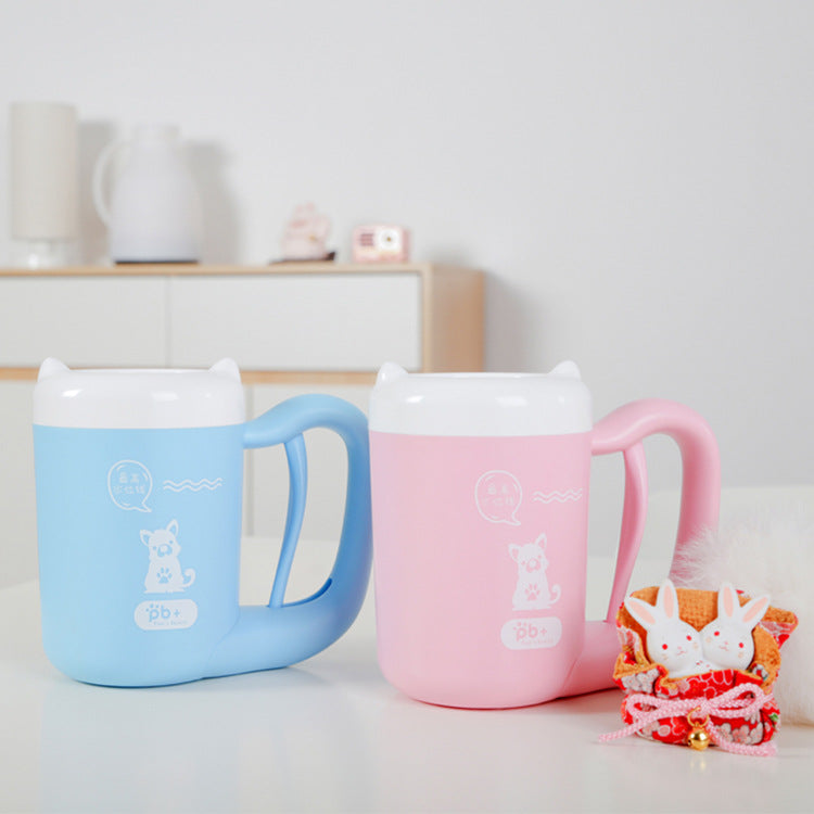Two colorful mugs with handles on a light surface, with a blurred background.