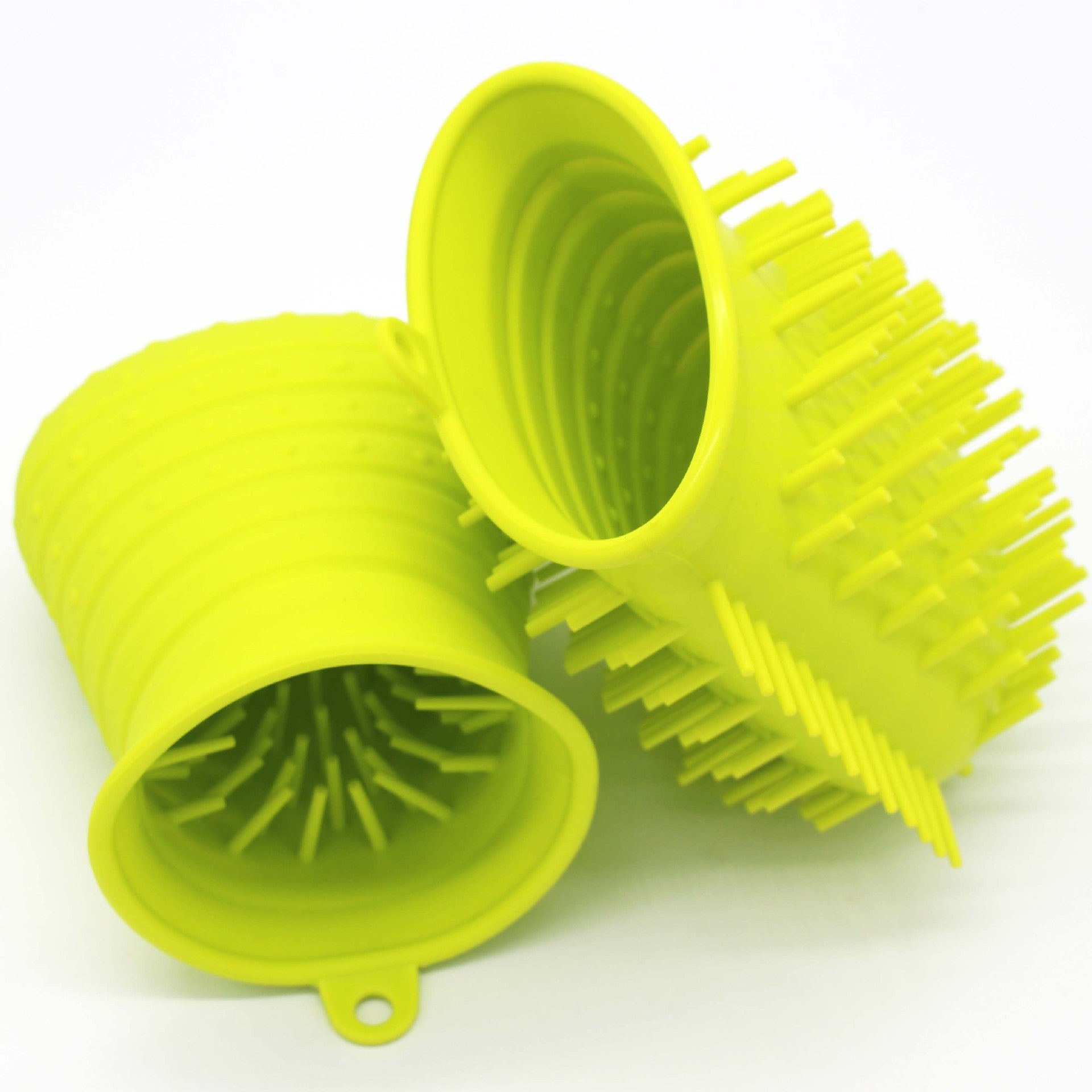 Two yellow silicone scrubbers on a white background