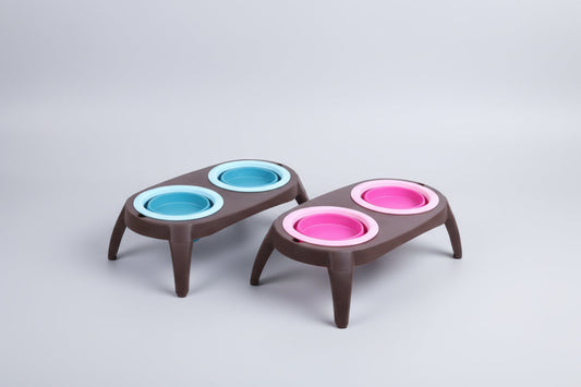 Two pet feeding stations with blue and pink bowls on a white background