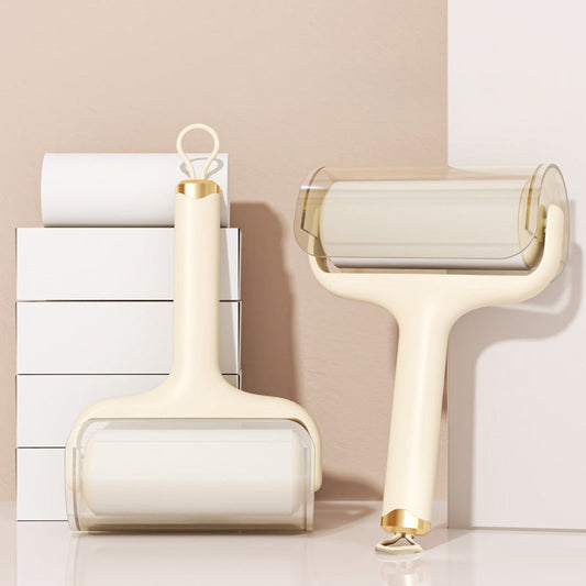 Two white cleaning rollers with gold accents on a light background